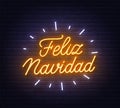 Feliz Navidad neon lettering on brick wall background. Royalty Free Stock Photo