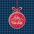 Feliz Navidad. Red Christmas ball with good wishes in Spanish. Royalty Free Stock Photo