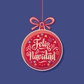 Feliz Navidad. Red Christmas ball with good wishes in Spanish. Royalty Free Stock Photo
