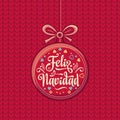 Feliz Navidad. Red Christmas ball with good wishes in Spanish. Royalty Free Stock Photo