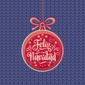 Feliz Navidad. Red Christmas ball with good wishes in Spanish. Royalty Free Stock Photo