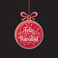 Feliz Navidad. Red Christmas ball with good wishes in Spanish. Royalty Free Stock Photo