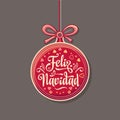 Feliz Navidad. Red Christmas ball with good wishes in Spanish. Royalty Free Stock Photo