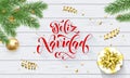 Feliz Navidad Spanish Merry Christmas holiday golden decoration on Xmas tree, calligraphy font for greeting card white wooden back Royalty Free Stock Photo