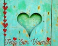Feliz San Valentin Abstract rustic soft green color with heart in the center and red heart glitter light Feeling of love and