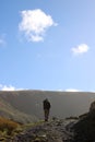 Fellwalker on footpath by Hayeswater Gill, Cumbria