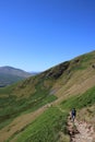 Fellwalker on hillside path, English Lake district