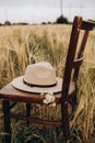 felt beige hat on a vintage chair in a field