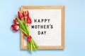 Felt board with text Happy Mother's day, red tulips bouquet on blue backround greeting holiday card Flat lay Top Royalty Free Stock Photo