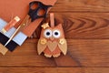 Felt brown owl toy. Shabby chic style. Kids crafts. Scissors, thread, needles, felt sheets - sewing kit. Brown wooden table