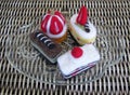 Felt cakes with strawberry and cherry on a clear glass plate Royalty Free Stock Photo