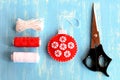 Felt Christmas tree ball, scissors, white and red threads, cord on blue wooden background. Hand made Christmas tree ornament. Step Royalty Free Stock Photo