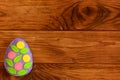 Felt Easter egg on wooden background with copy empty space for text. Bright egg ornament made of felt