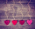 Felt fabric love valentine's hearts hanging on rustic driftwood Royalty Free Stock Photo