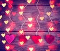 Felt fabric valentine's hearts hanging on rustic driftwood Royalty Free Stock Photo