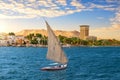 Felucca in the blue waters of Nile, Aswan city, Egypt Royalty Free Stock Photo