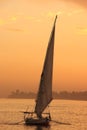 Felucca boat sailing on the Nile river at sunset, Luxor Royalty Free Stock Photo