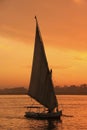 Felucca boat sailing on the Nile river at sunset, Luxor Royalty Free Stock Photo