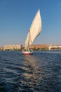 A felucca, a traditional wooden sailing boat, carrying tourists on the Nile river at Aswan Royalty Free Stock Photo