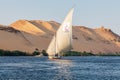 A felucca, a traditional wooden sailing boat, carrying tourists on the Nile river at Aswan Royalty Free Stock Photo