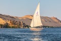 A felucca, a traditional wooden sailing boat, carrying tourists on the Nile river at Aswan Royalty Free Stock Photo