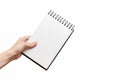 Femal hand holding white sketchbook . Royalty Free Stock Photo