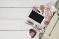 Female accessories falling from handbag on wooden background with copyspace