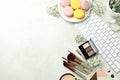 Female accessories and macaroons on white textured background