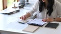 Female accountant checking financial reports and using calculator. Royalty Free Stock Photo