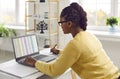 Female accountant sitting at her office desk and working with spreadsheets on her laptop Royalty Free Stock Photo