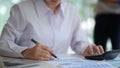 Female accountants are checking company revenue from the impact of a virus outbreak Royalty Free Stock Photo