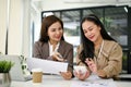 Female accountants are working and analyzing financial data reports in the office together Royalty Free Stock Photo