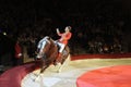 Female acrobat artist riding well trained horse performing in the ring of the National Kiev circus