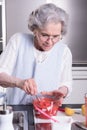 Female active pensioner is preparing strawberries Royalty Free Stock Photo