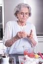 Female active pensioner is preparing strawberries Royalty Free Stock Photo