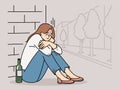 Female addict sit on ground with wine bottle