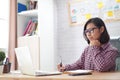 Female administrative assistant checking report on laptop