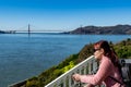 Female adult while enjoying the skyline view of San Francisco USA and Golden Gate Bridge from Viewing Deck in Alcatraz Island Royalty Free Stock Photo