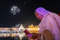 Female adult Gurunanak Devotee reading Guru Vani during the Diwali, close-up