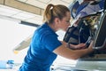 Female Aero Engineer Working On Helicopter In Hangar