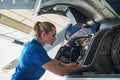 Female Aero Engineer Working On Helicopter In Hangar