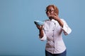 Female african american cook showing light blue bowl Royalty Free Stock Photo