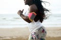 Female african runner jogging during outdoor workout on beach Royalty Free Stock Photo