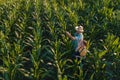 Female agronomist advising corn farmer in crop field