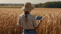 Female agronomist, farmer standing on field with wheat checking data on tablet.