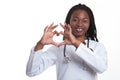 Female american african doctor, nurse woman wearing medical coat with stethoscope doing heart with hands. Happy excited for