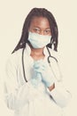 Female american african doctor, nurse woman wearing medical coat with stethoscope, mask and gloves. Happy excited for success Royalty Free Stock Photo