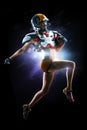 female american football player in uniform and jersey T-shirt posing with helmet isolated on black background Royalty Free Stock Photo