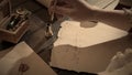 Female in antique outfit writes with feather pen. Close up shot of woman dips vintage quill feather pen in inkwell