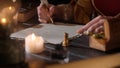 Female in antique outfit writes with feather pen. Focus on woman in renaissance dress writing a letter with vintage Royalty Free Stock Photo